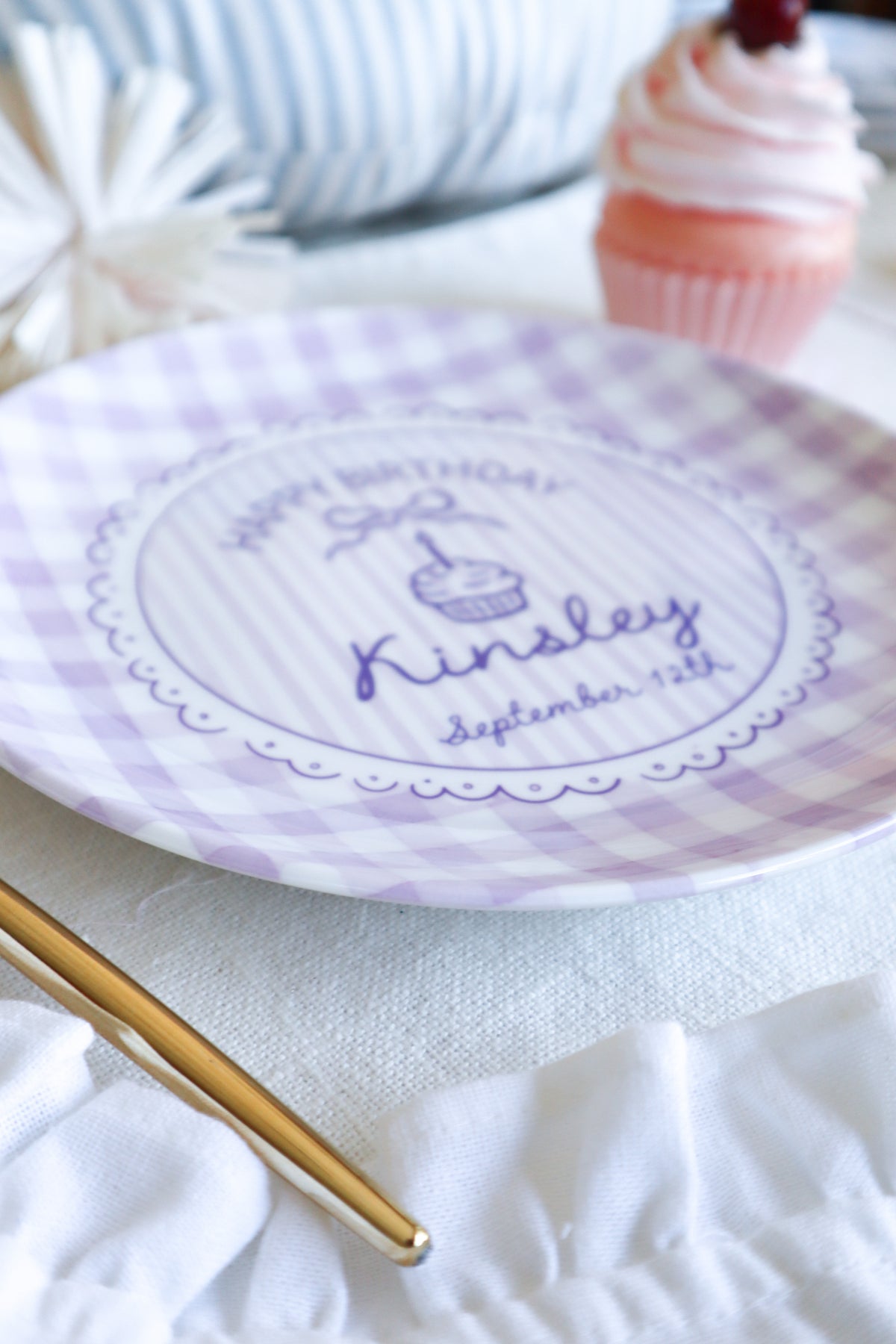 Round ceramic plate with Lavender gingham boarder. Happy Birthday with a cupcake in the center. Personalized name and birth date