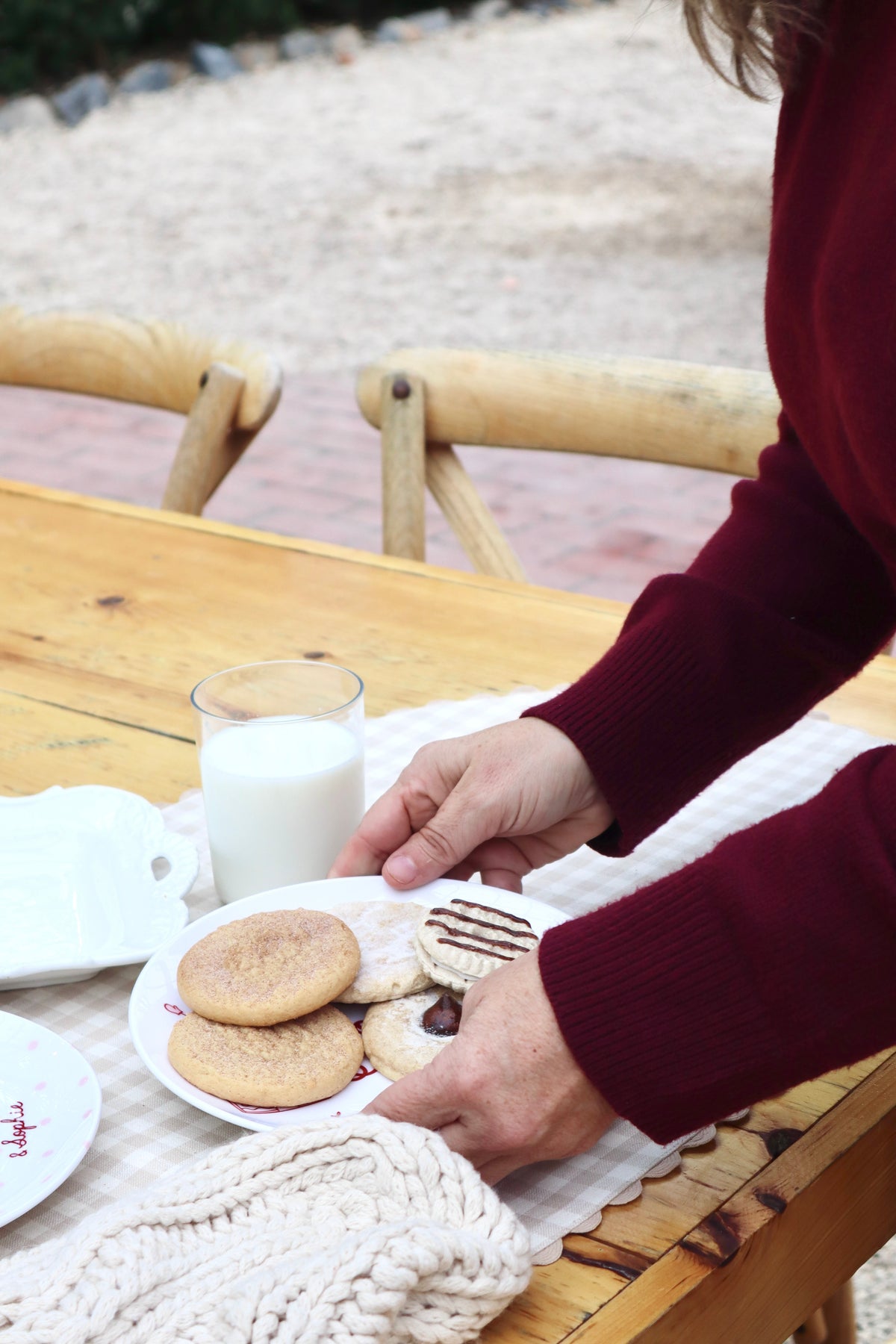 Plate of cookies for santa. Hands holding plate. Ceramic Christmas plate