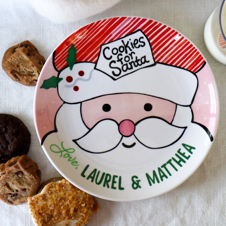 Cookies for Santa with red , pink and green. Holly in Santa 
 hat, tag and striped red hat