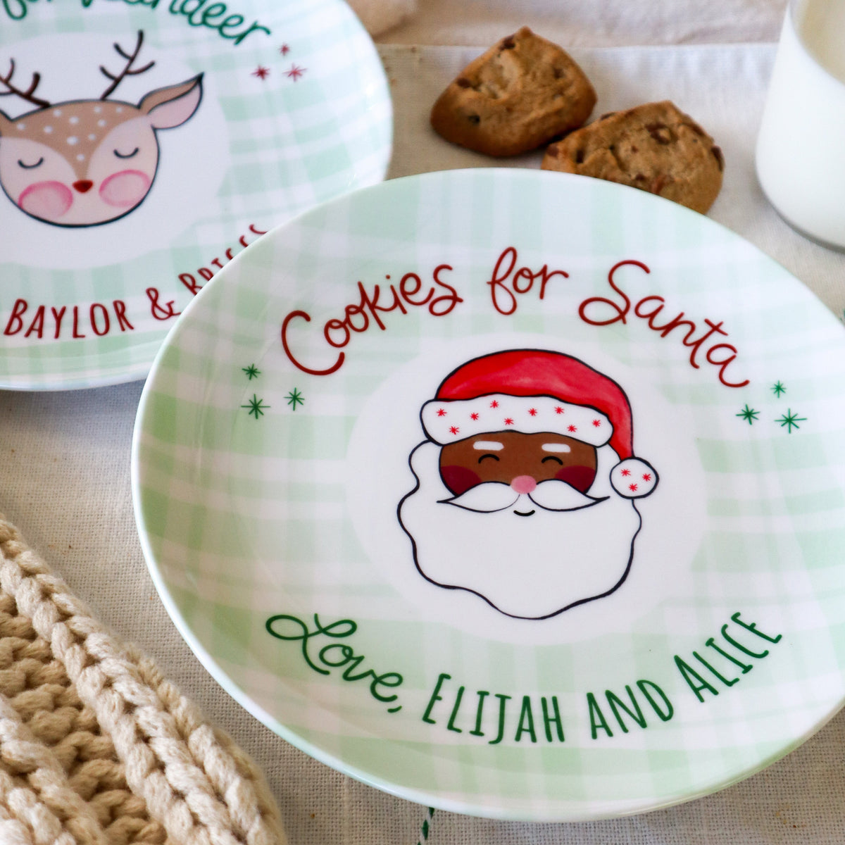 Cookies for Santa round ceramic plate. personalized with love and names. reindeer plate in backgroung matching santa plate. black santa in center of the 
plate.
